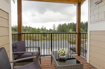 a patio with two chairs and a coffee table